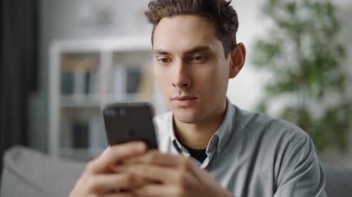 Young Adult Using Mobile Phone at Home Indoors