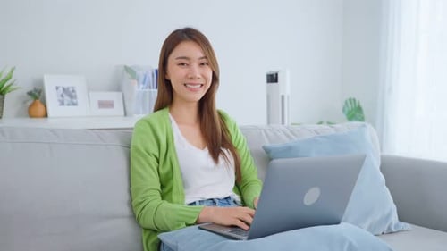 Woman Working on Laptop in Living Room