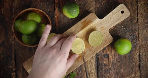 Men Hands Cut Lime on the Cutting Board