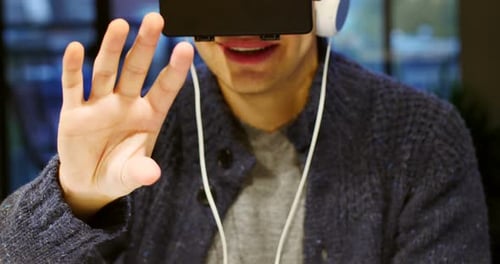Man Wearing VR Headset Interacting with Simulation