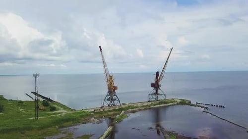 Two Old Rusty Cranes in the Seaport