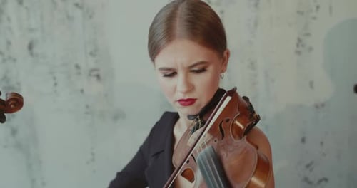 Woman with Auburn Hair Plays Violin