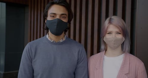 People Wearing Face Masks Standing Together Outside