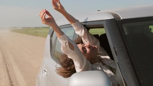 Woman Hanging Out Of Car Window
