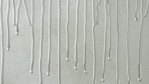 Silver Paint Background Color Tint Drops on Grey Wall Closeup