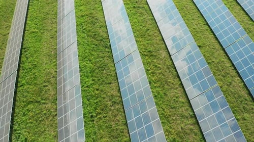 Photovoltaic Solar Cells Reflect Sky on Surface at Station