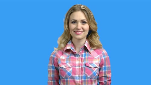 Smiling Woman with Blonde Hair on Blue Background