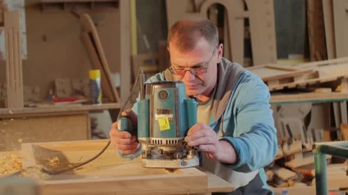 Carpenter sanding a wooden frame