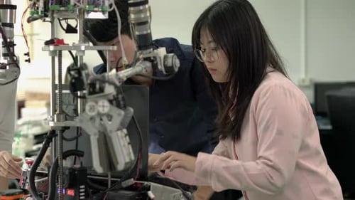 Startup student are coding software with assembling and testing electric robotics