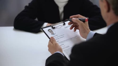 Hiring Manager Marking Female Candidate Resume and Shaking Hands, Hiring