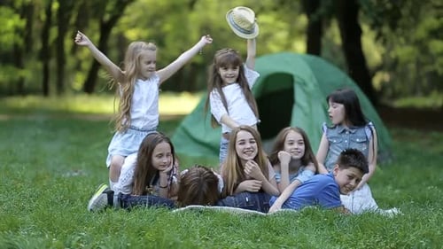 Happy Children Gather Near Tent on Green Lawn