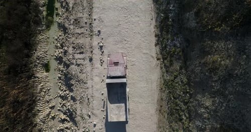 Truck Driving Along Rural Dirt Road Aerial