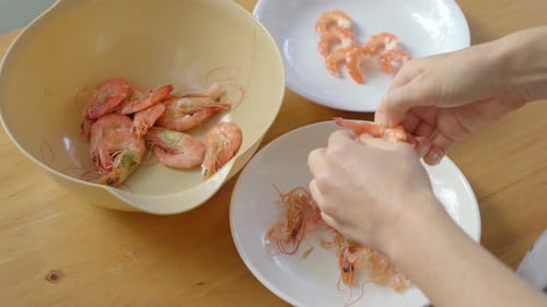 Hands Peeling Delicious Boiled Shrimp for Recipe