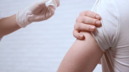 Medical Professional Administering Injection to Adult Patient