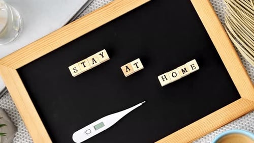 Stay at Home Message with Thermometer on Chalkboard