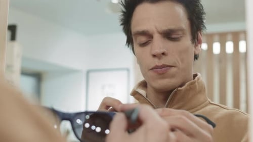 Good-looking Man Choosing New Sunglasses