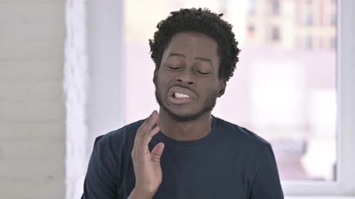 Young Adult Man Experiencing Toothache or Jaw Pain