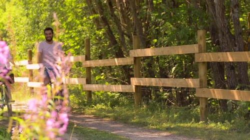 Happy Couple Riding Bicycles at Summer Park