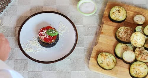 Preparing Vegetarian Eggplant Parmigiana Dish With Cheese