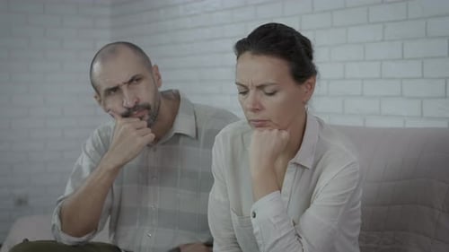Upset Woman with Man Indoors