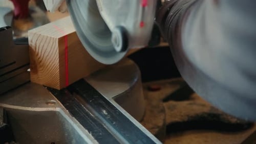 Close Up of Carpenter's Hands Cutting Wood with Table Saw in Workshop, Craftsman Furniture