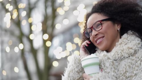 Smiling Woman Talking on Phone Outdoors in the City