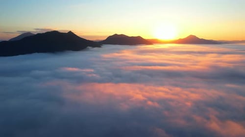 Aerial Sunrise Over Clouds and Mountain Landscape