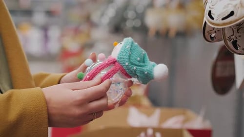 Hands Holding a Christmas Tree Ornament Close Up