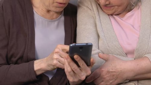 Senior Women Looking at Mobile Phone Together