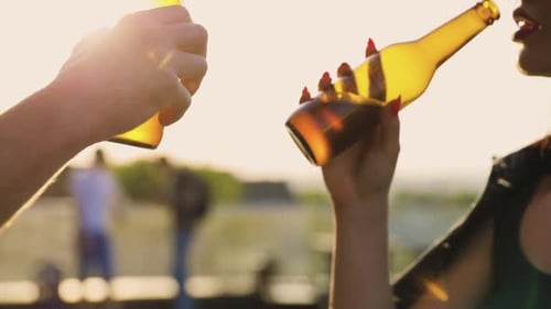 Young Adults Toasting Beers at Rooftop Party