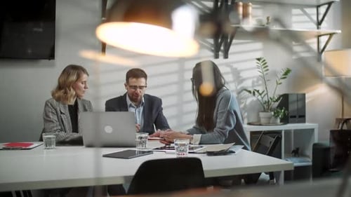 Colleagues And Clients Talking Strategy With Laptop And Tablet. In Creative Office Productive