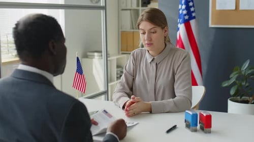 Woman Talking with Visa Officer in U.S. Embassy