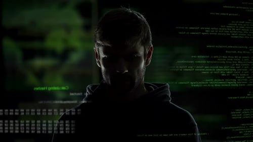 Dark Silhouette Amidst Scrolling Green Code