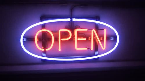 Open neon sign flickering shine in the night. Bar, pub or shop entrance. 4KHD