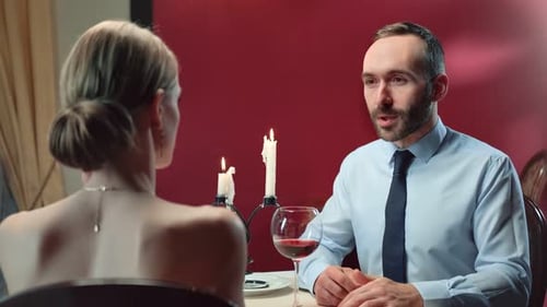 Romantic Evening: Couple at a Candlelit Dinner