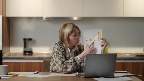 Woman Presents Graph on Laptop During Video Call