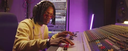 African American Sound Engineer Working in Recording Studio