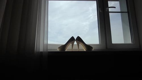 Elegant High Heels on Window Sill in Natural Light