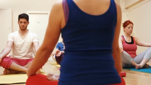 Yoga Students Meditating Together in Class