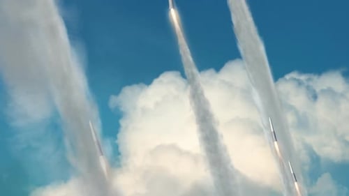 Multiple Rockets Launching into Blue Sky Through Clouds