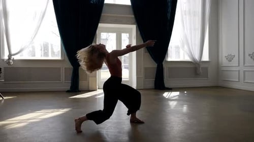 Talented Young Woman is Dancing Alone in Dance Hall Practicing Modern Choreography
