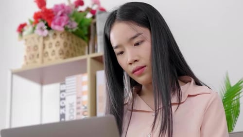Woman Working on Laptop at Home