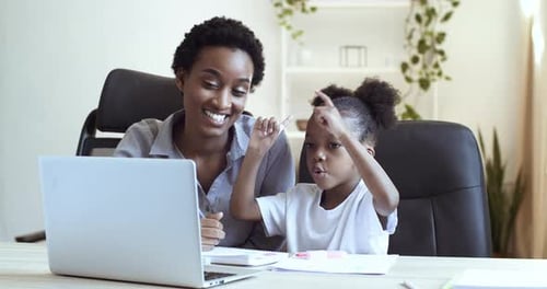 Mother and Child Looking at Laptop Together at Home