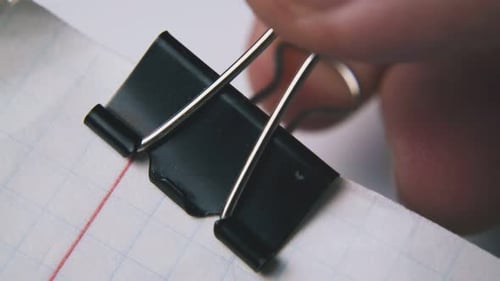 Binder Clip Attaches to Graph Paper Close Up