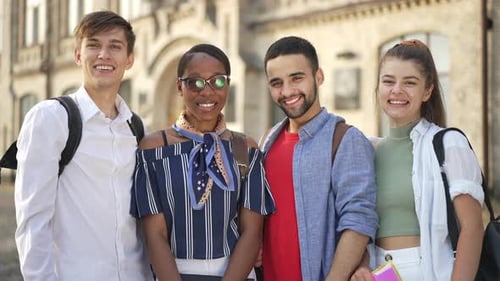 Smiling Students Give Thumbs Up Near School