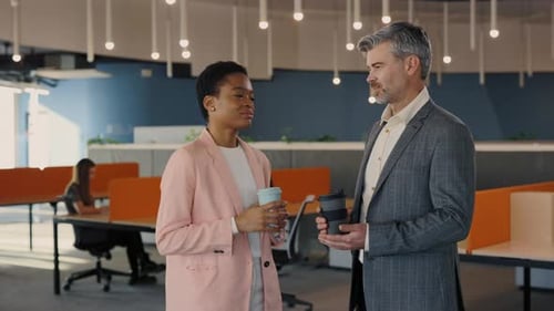 Diverse Friendly Coworkers Talking Standing in Modern Office