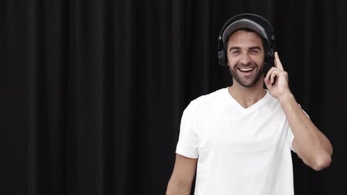 Man Puts On Headphones and Smiles Happily