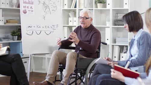 Man in Wheelchair Presents at Office Meeting