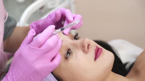 Woman Receives Forehead Cosmetic Injection Close Up