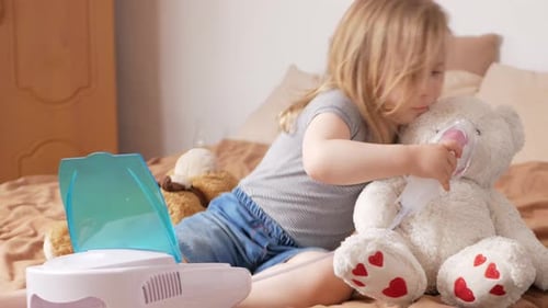 Girl Gives Nebulizer Treatment to Stuffed Bear